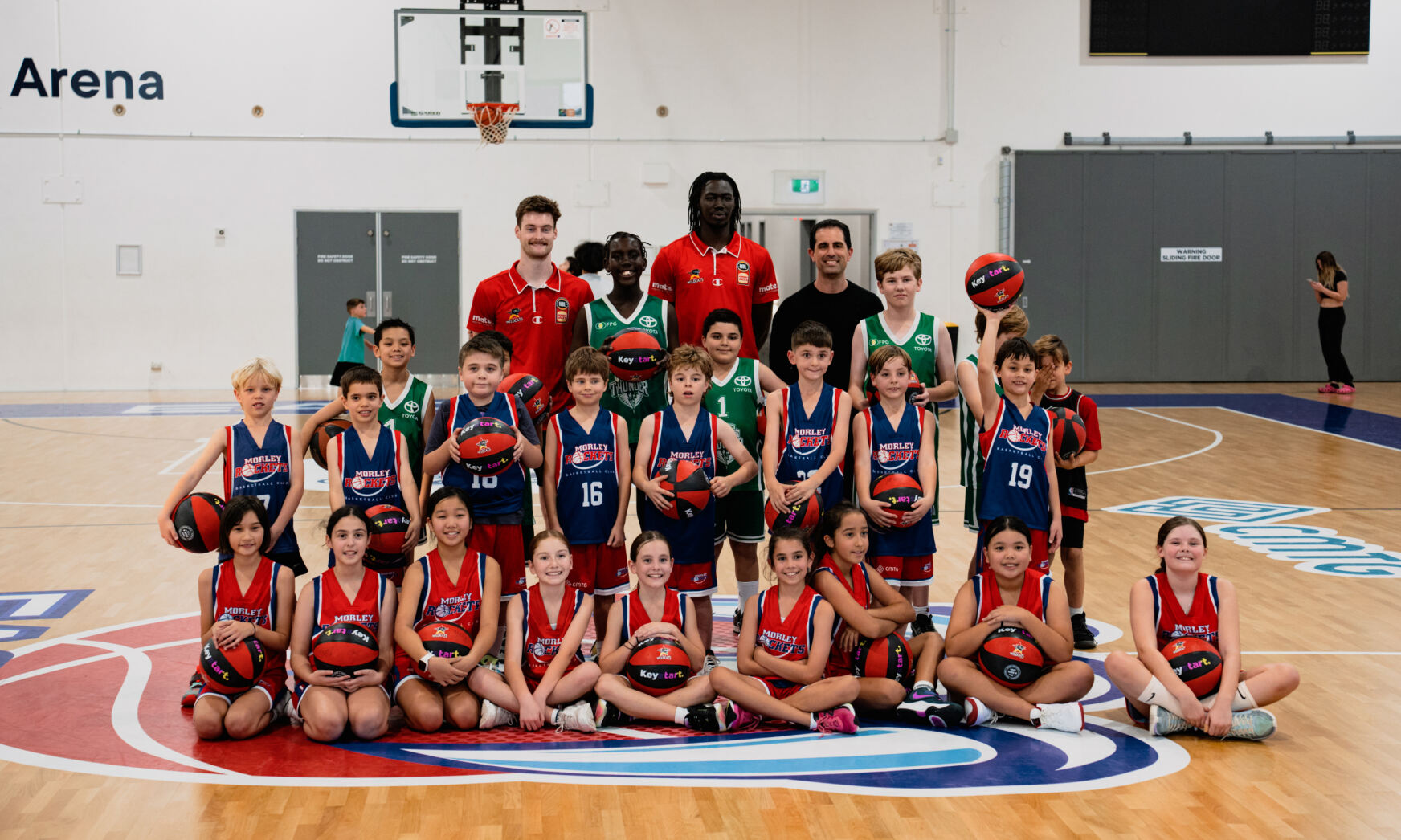 CMTG-sponsored children smiling and posing with basketballs, showing their enthusiasm for sport and community participation